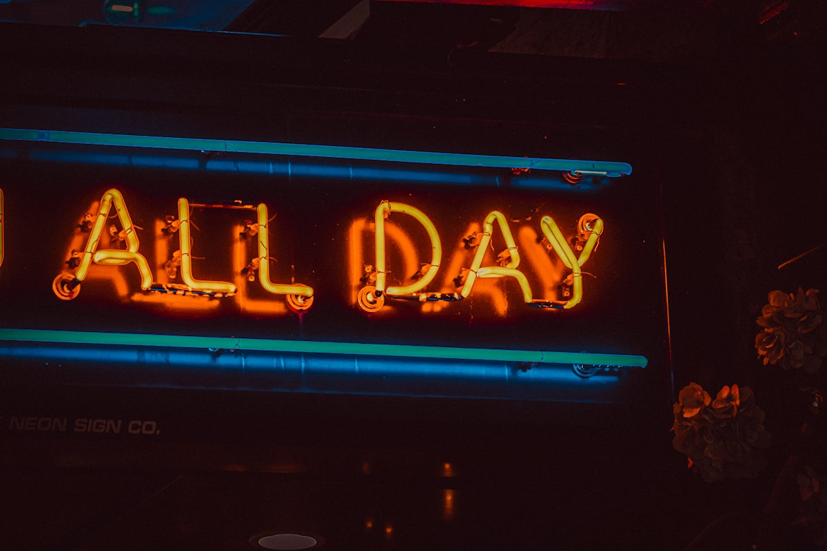 a neon sign that says all day on it
