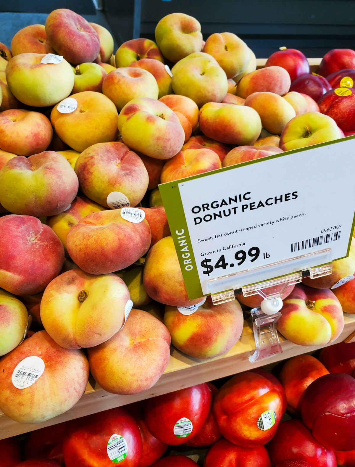 Fresh organic donut peaches displayed for sale