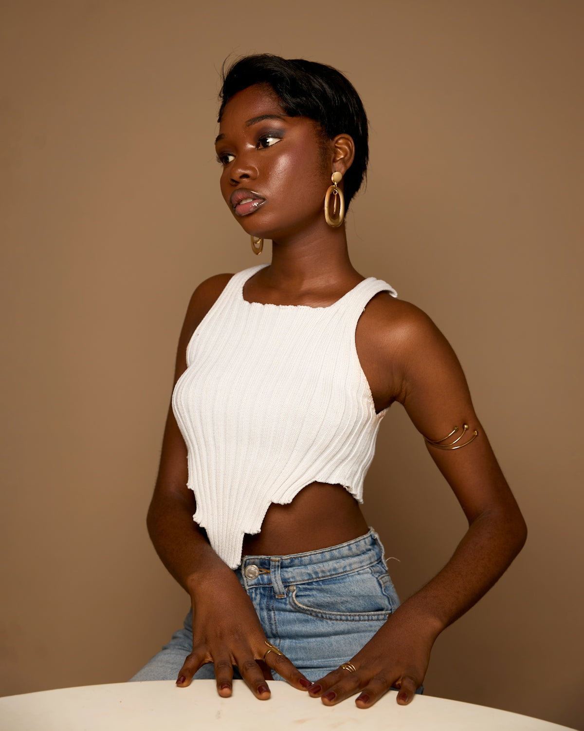 Young woman wearing a white crop top and jeans