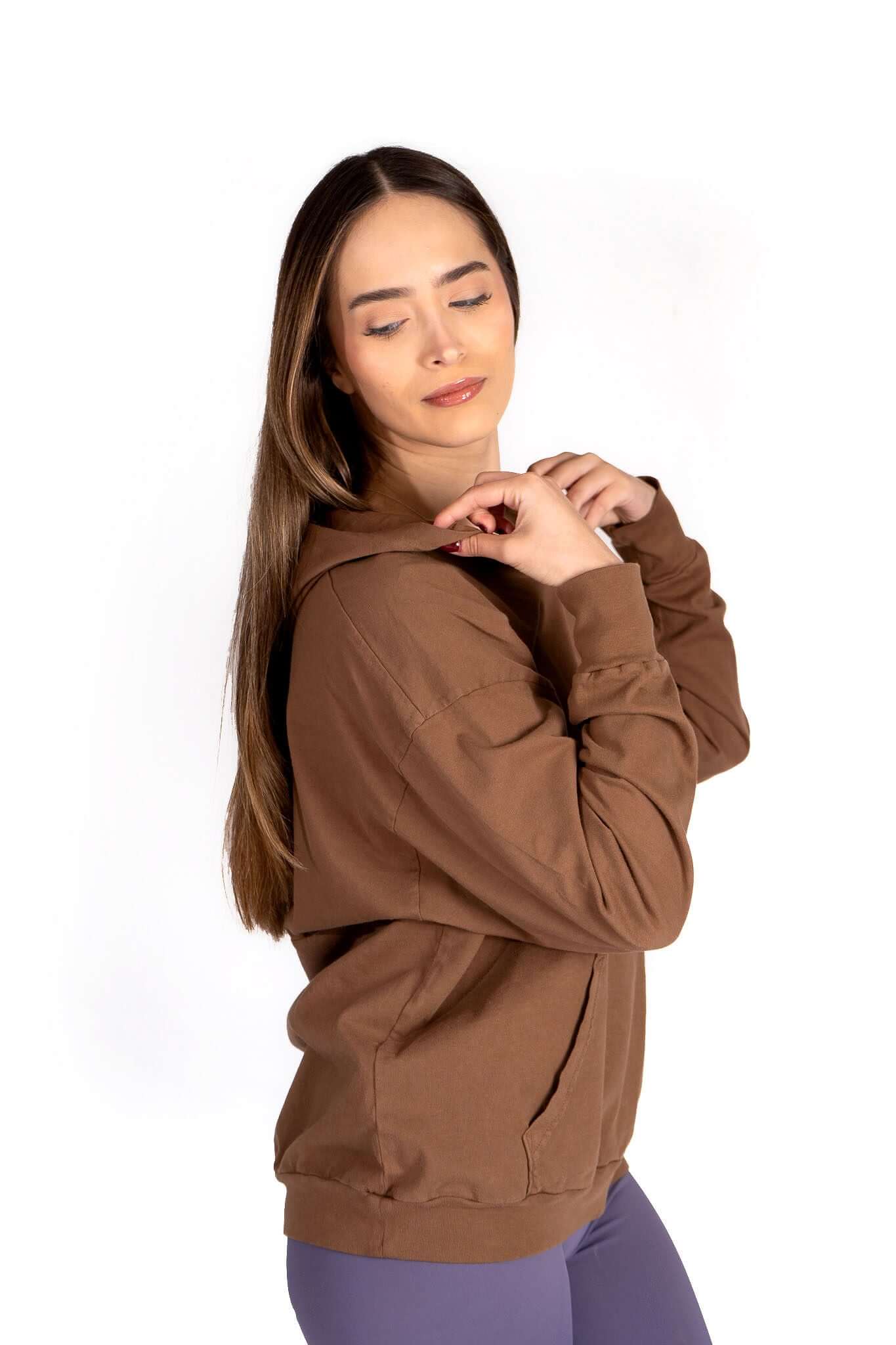 Model wearing the Relax Hoodie in brown, featuring a cozy oversized fit and spacious kangaroo pocket.