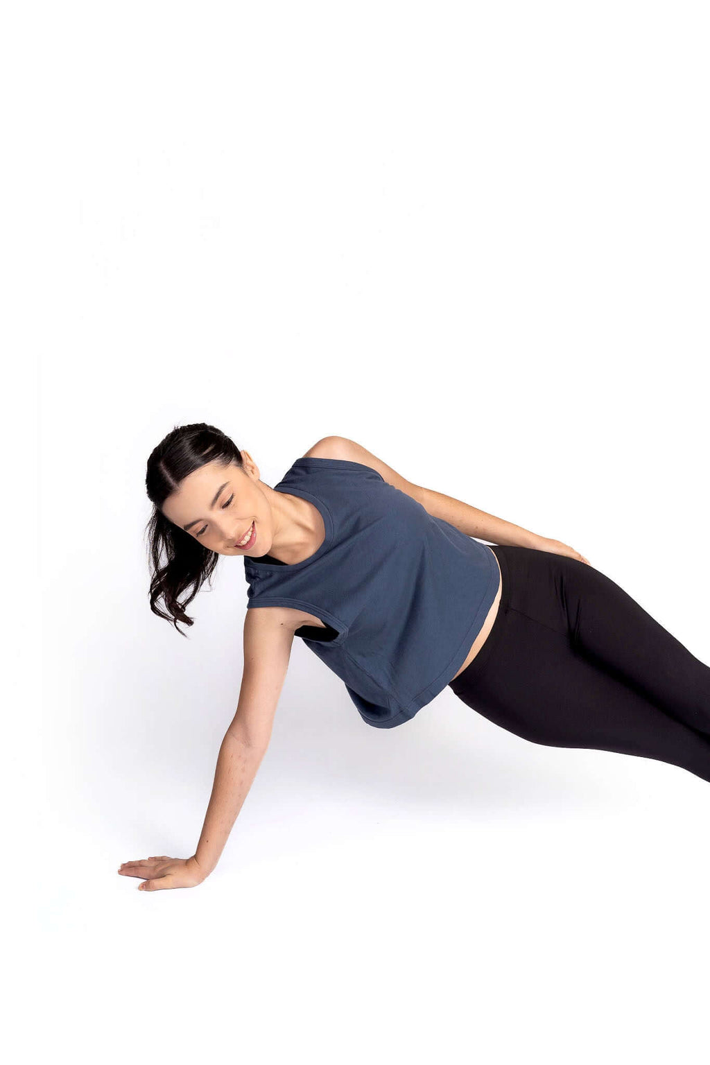 Woman in a yoga pose on a white background