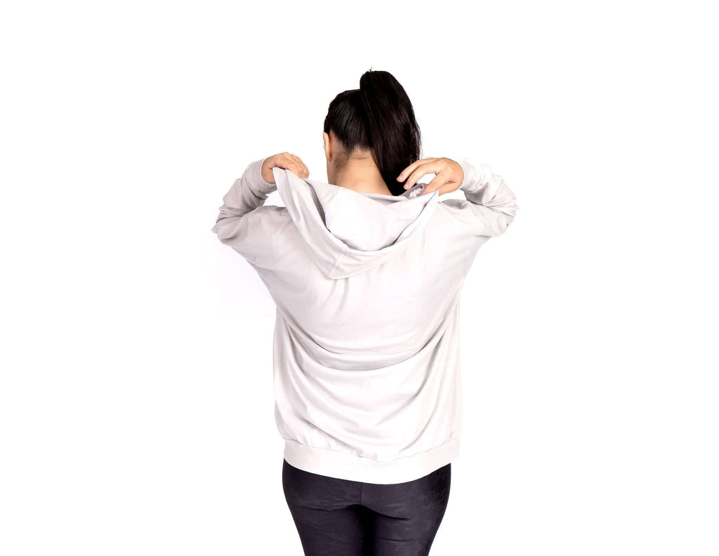Woman wearing a Relax Hoodie, showcasing the generous hood and soft fabric for a cozy feel.