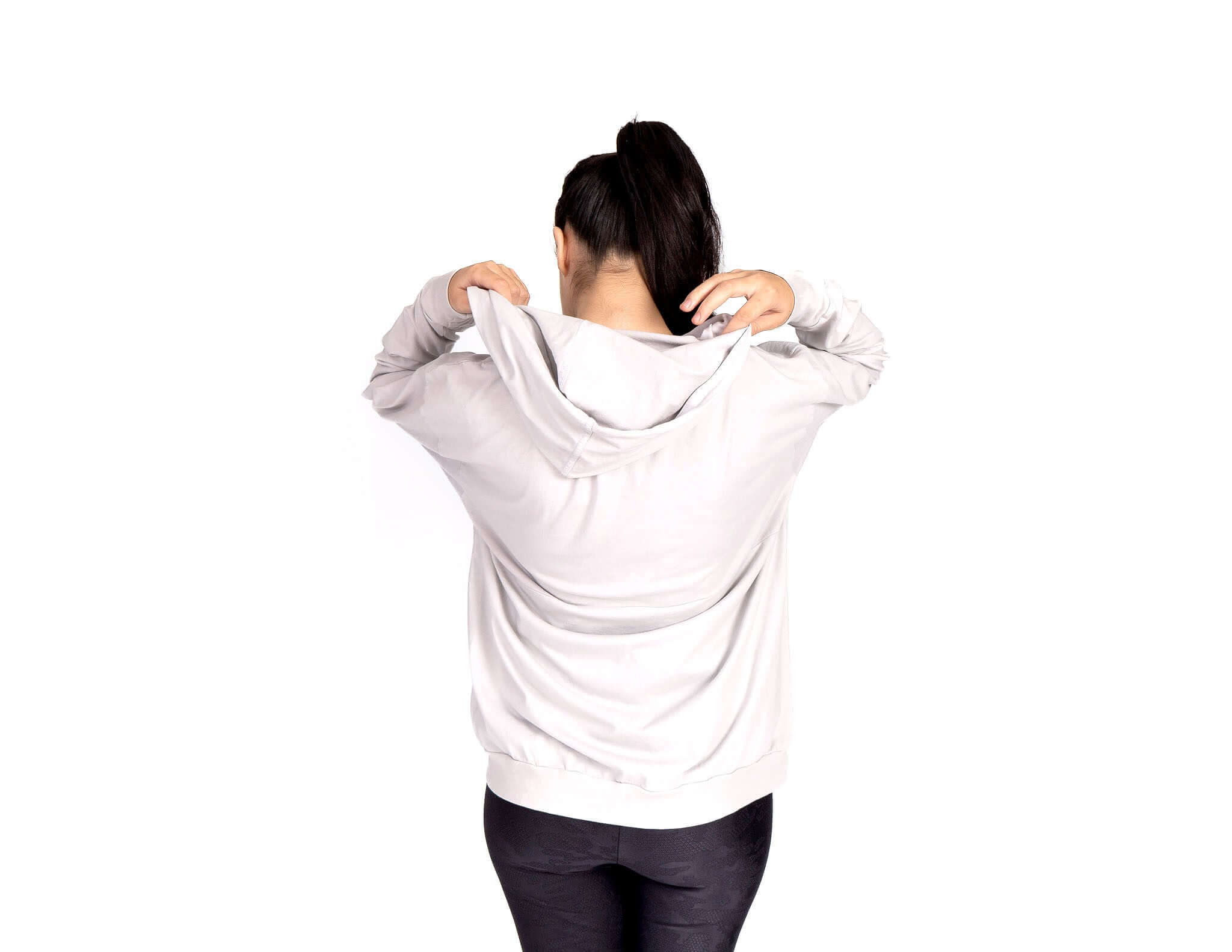 Woman wearing a Relax Hoodie, showcasing the generous hood and soft fabric for a cozy feel.