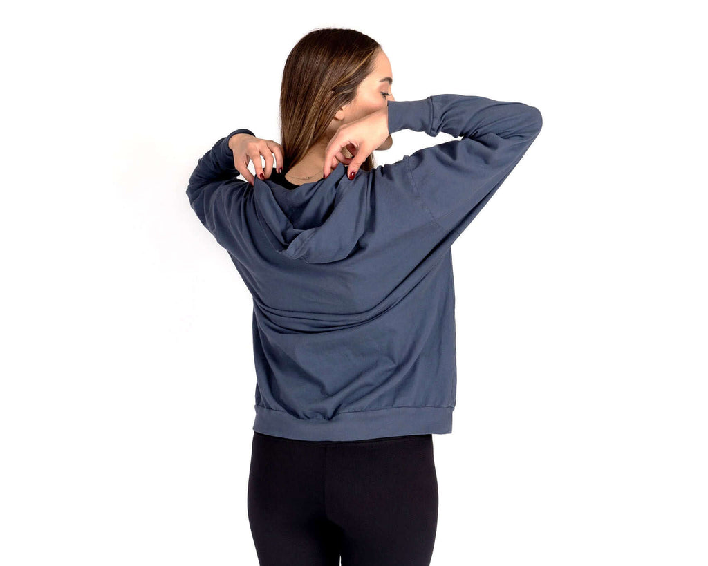 Back view of a woman wearing the Relax Hoodie, showcasing its oversized fit and cozy design.
